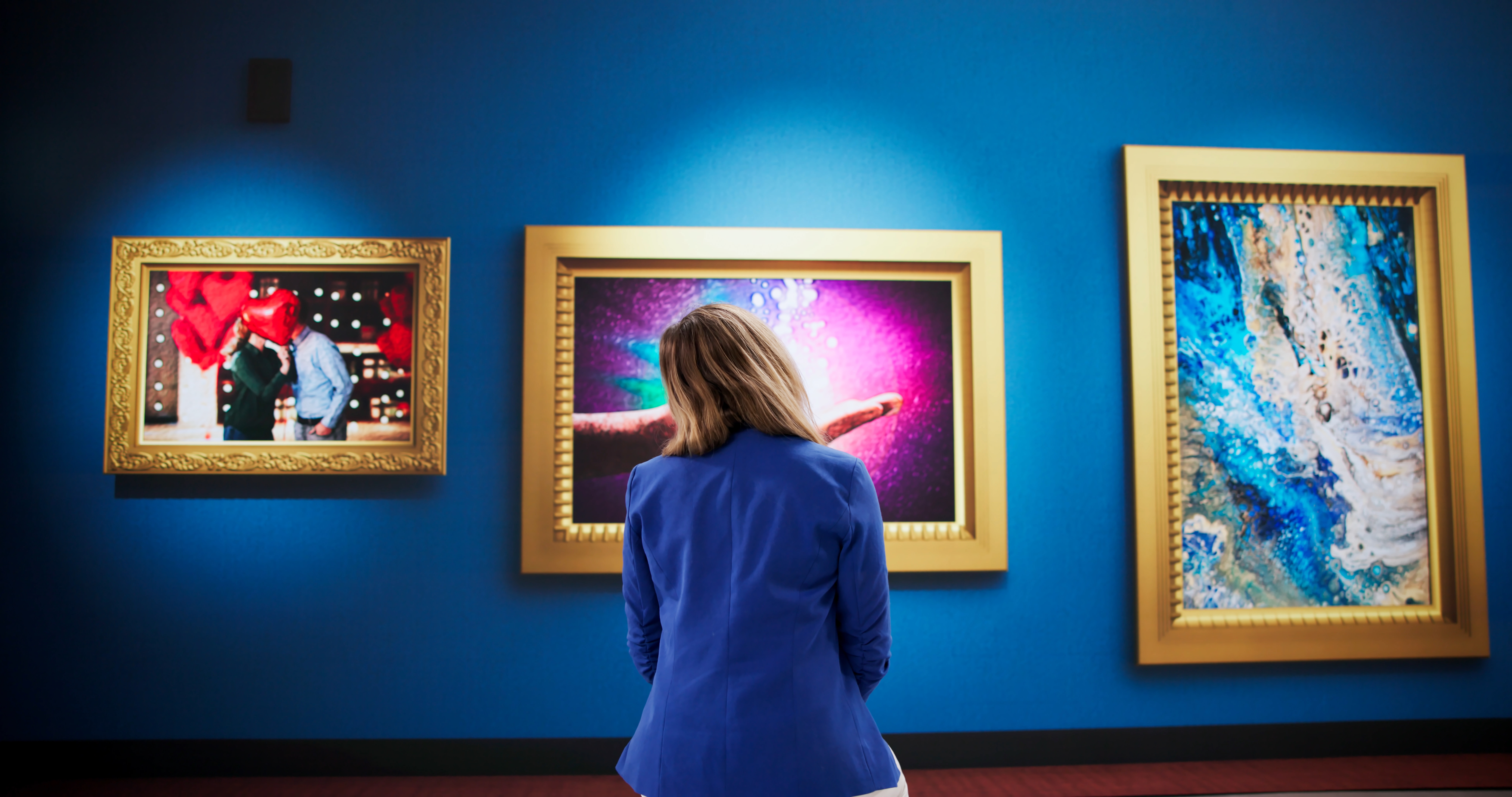 Young Female Observer Studying Vibrant Artwork During Crowded Gallery Exhibition
